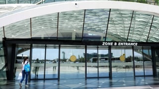 view at the entrance of airport with woman entering the door new modern airport terminal