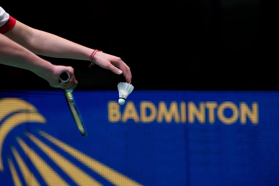Badminton Player With Racket And Shuttlecock